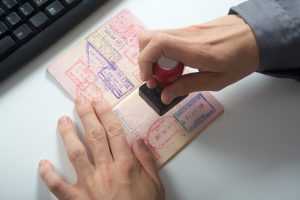 An immigration control office stamping a seal in a passport