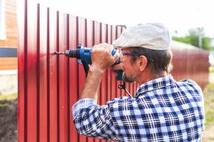Man building a fence