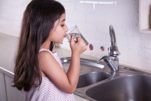 a little girl drinking water